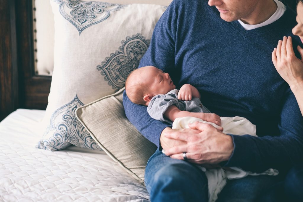 Baby sleeping on fathers' lap